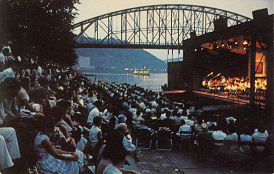 American Wind Symphony performing from Point Counterpoint II before a riverside audience at night